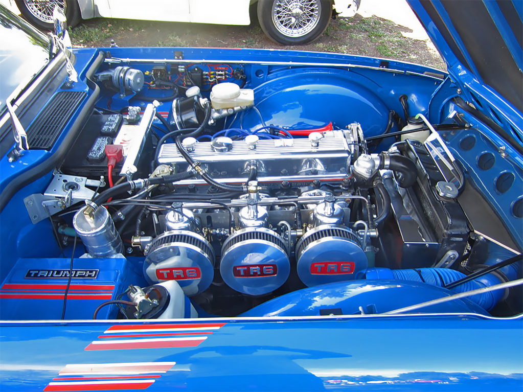 Rare triple-carburetor TR6 engine.